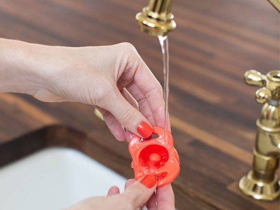 woman washing a all in one silicone pacifier