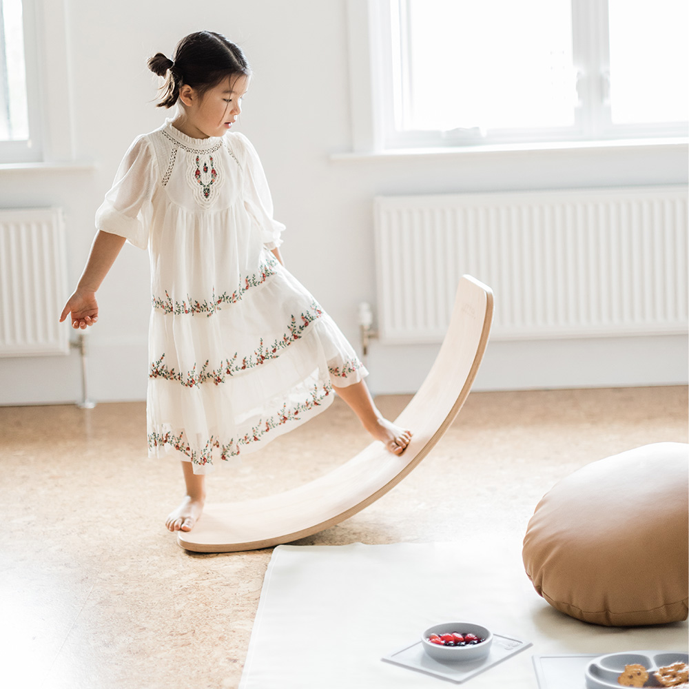 five year old girl using a Wobbelboard